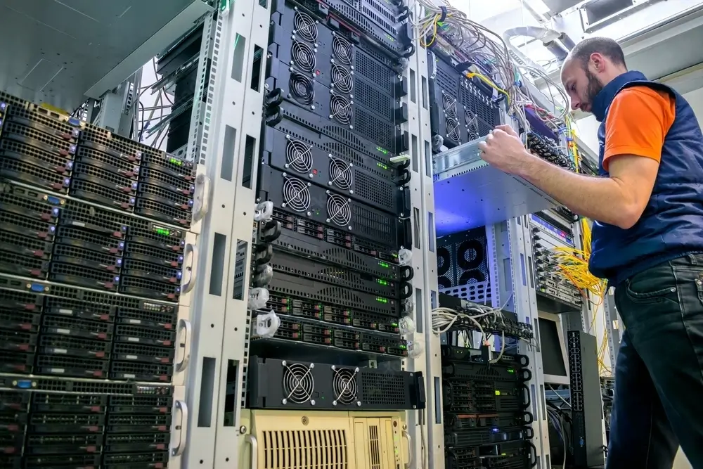 An individual in a workplace observing a server.