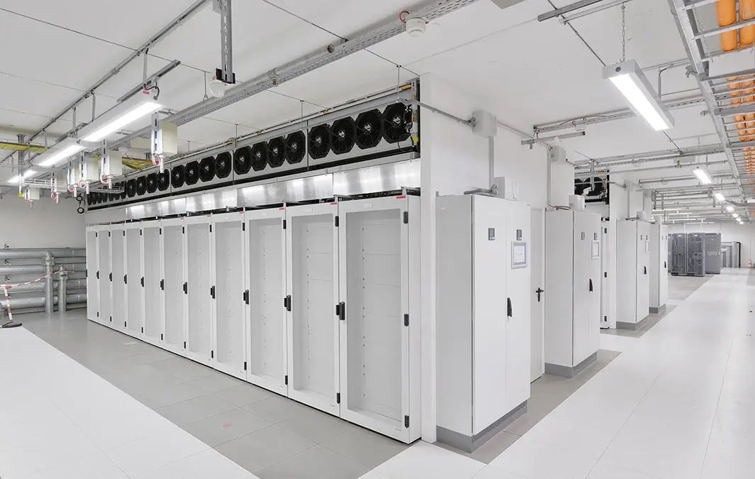 A spacious room filled with multiple rows of servers, storing and processing data efficiently.